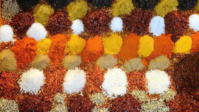 Exotic spices spilling from glass apothecary jars