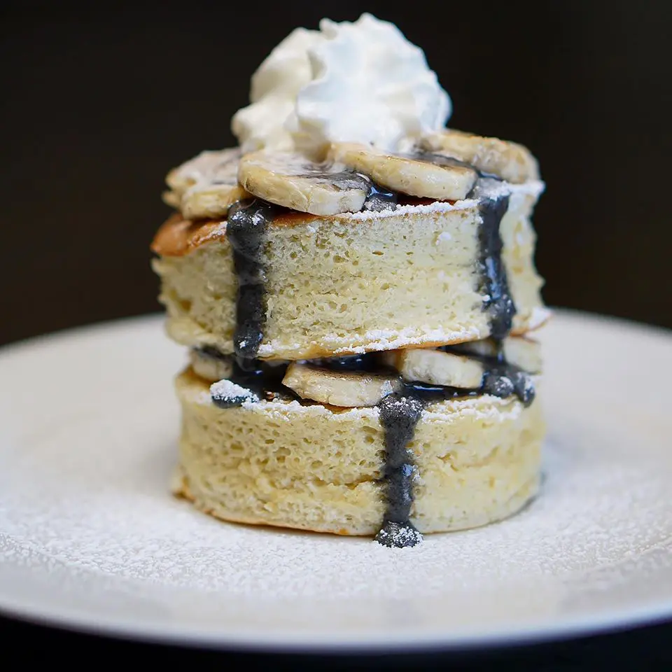 A towering stack of fluffy Japanese pancakes
