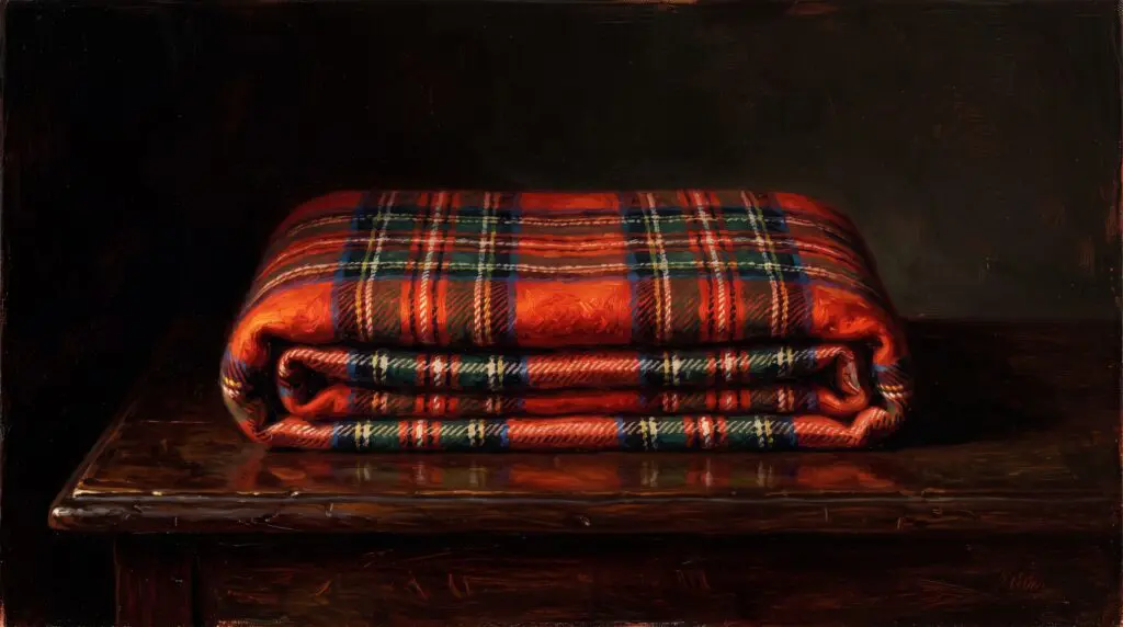 The cover of the mystery novel The Family Upstairs, resting on a cozy knitted blanket next to a mug of hot tea.