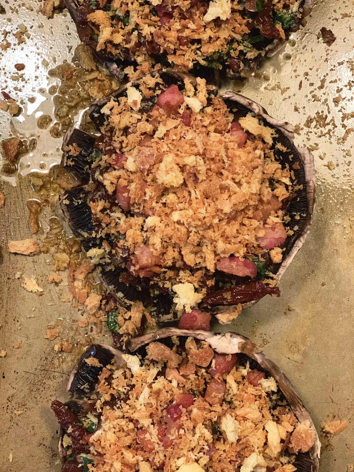 Portobello caps stuffed with the tomato and pancetta crumb, on the baking tray