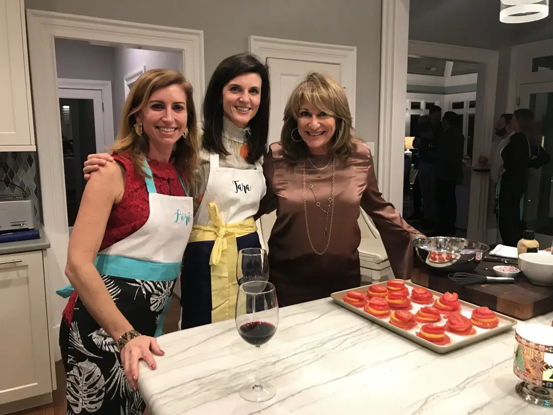 Jorj laughing with her guest chefs in the kitchen