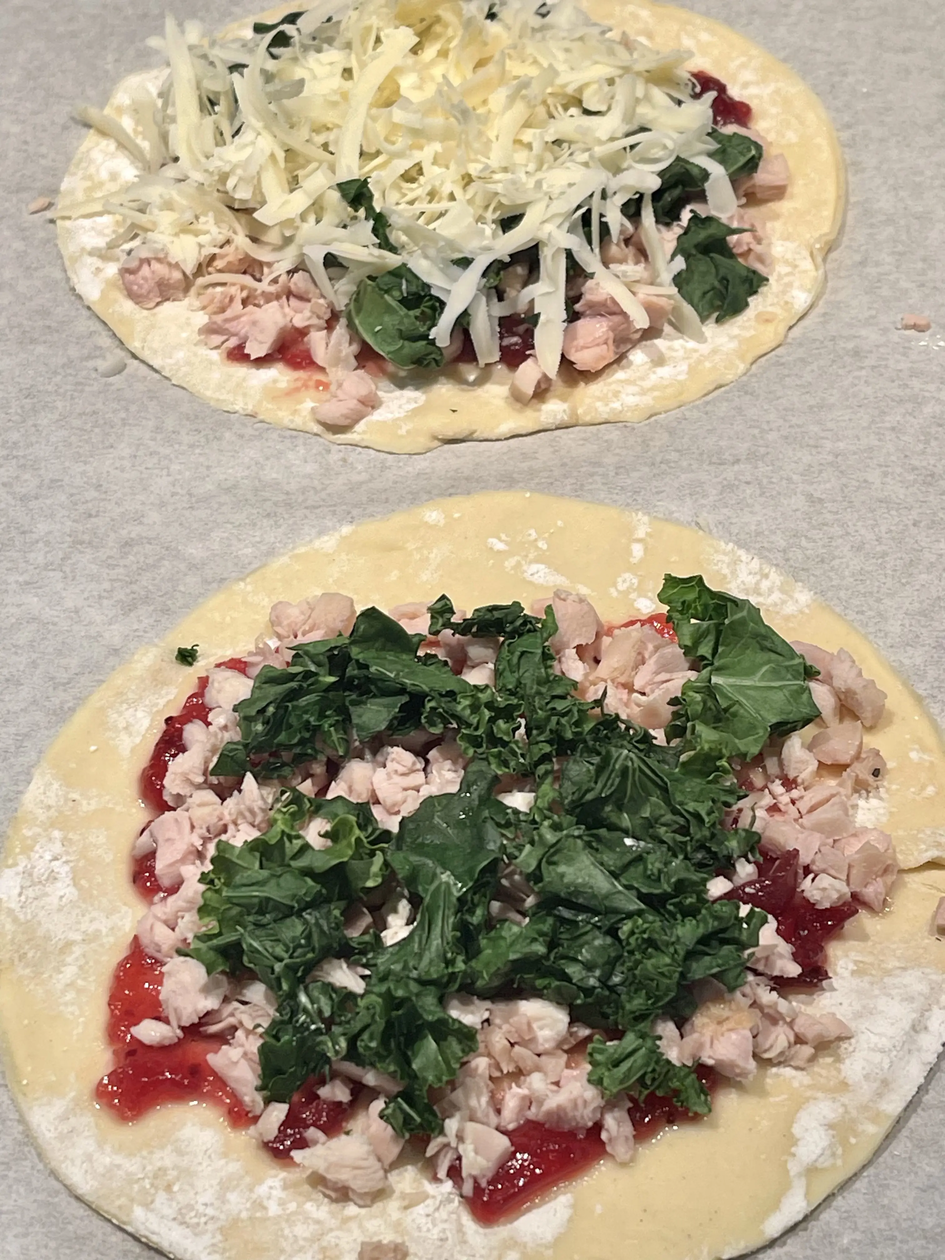 Puff pastry disks spread with cranberry sauce, turkey, greens and cheese