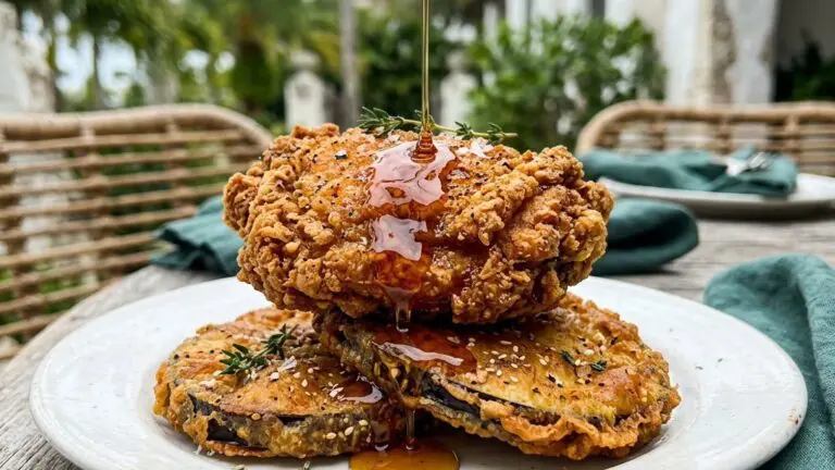 Stunning plated serving of Oven “Fried” Chicken with Eggplant with Hot Maple Drizzle, a chef-tested recipe by Chef Jorj Morgan.