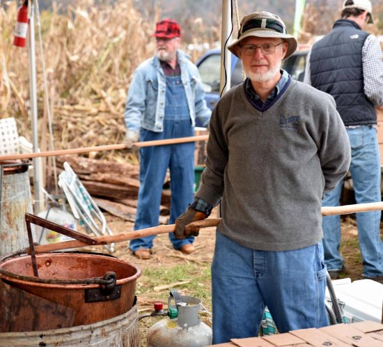 A church member stirring apple butter at the Valle Country Fair
