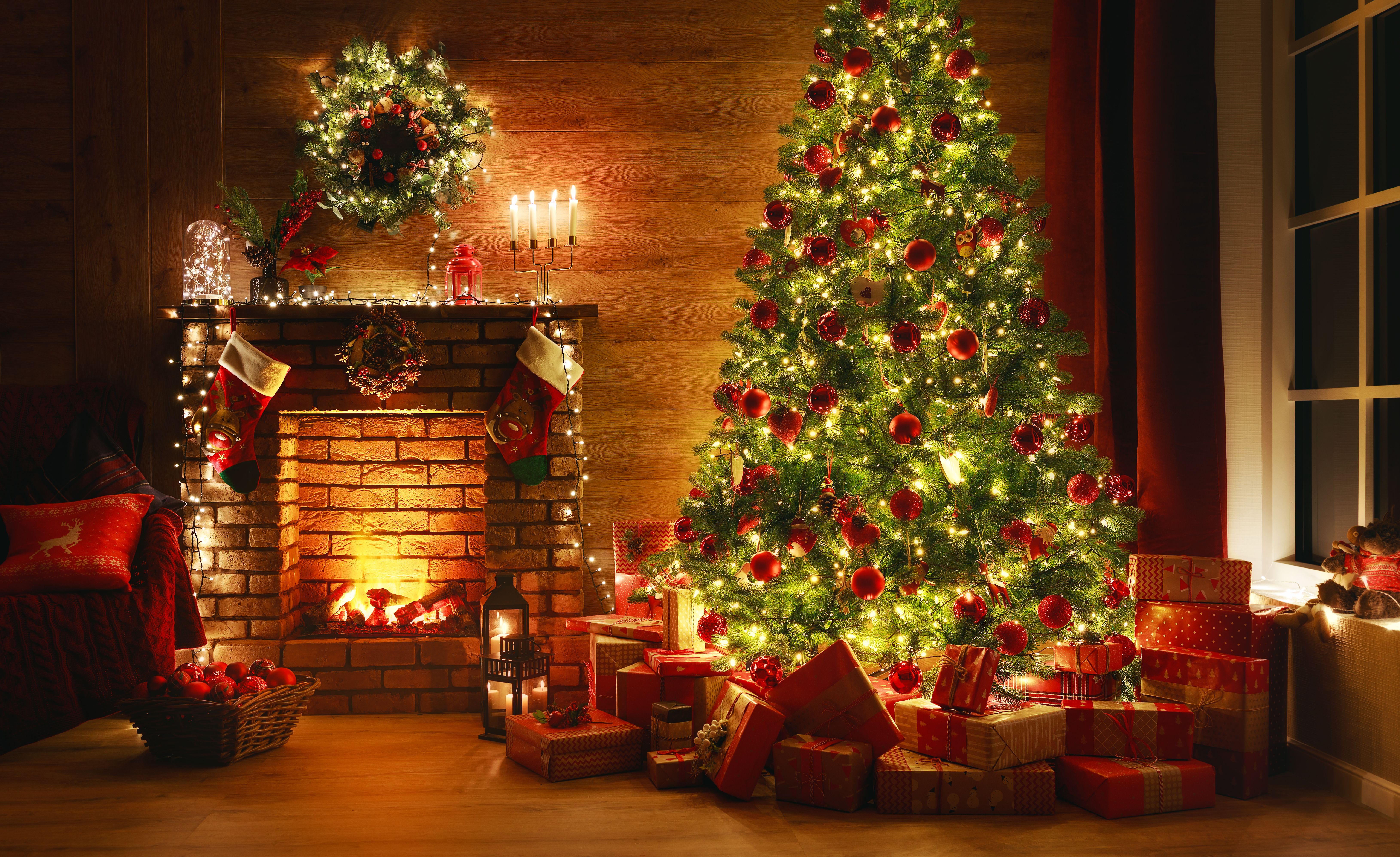 interior christmas. magic glowing tree, fireplace, gifts in  dark at night