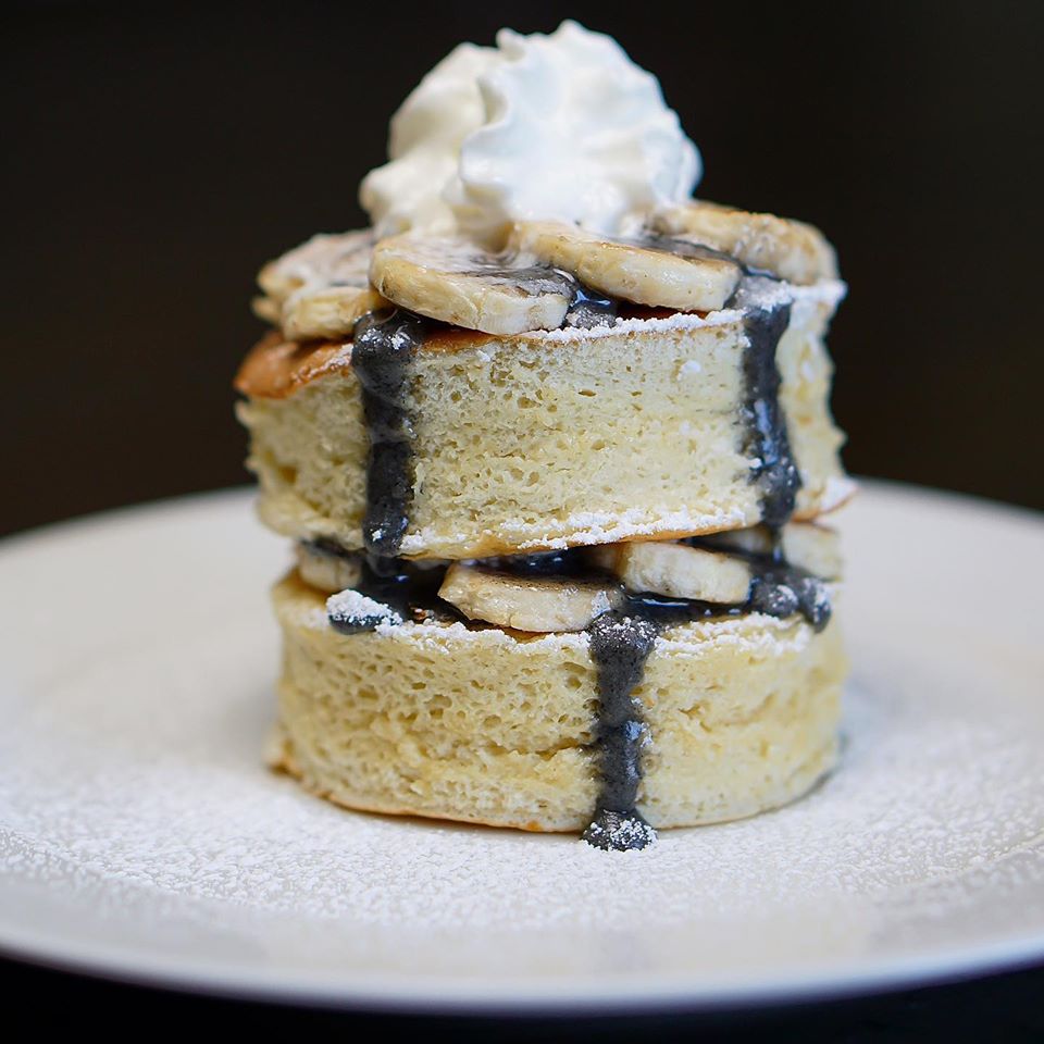 A towering stack of fluffy Japanese pancakes