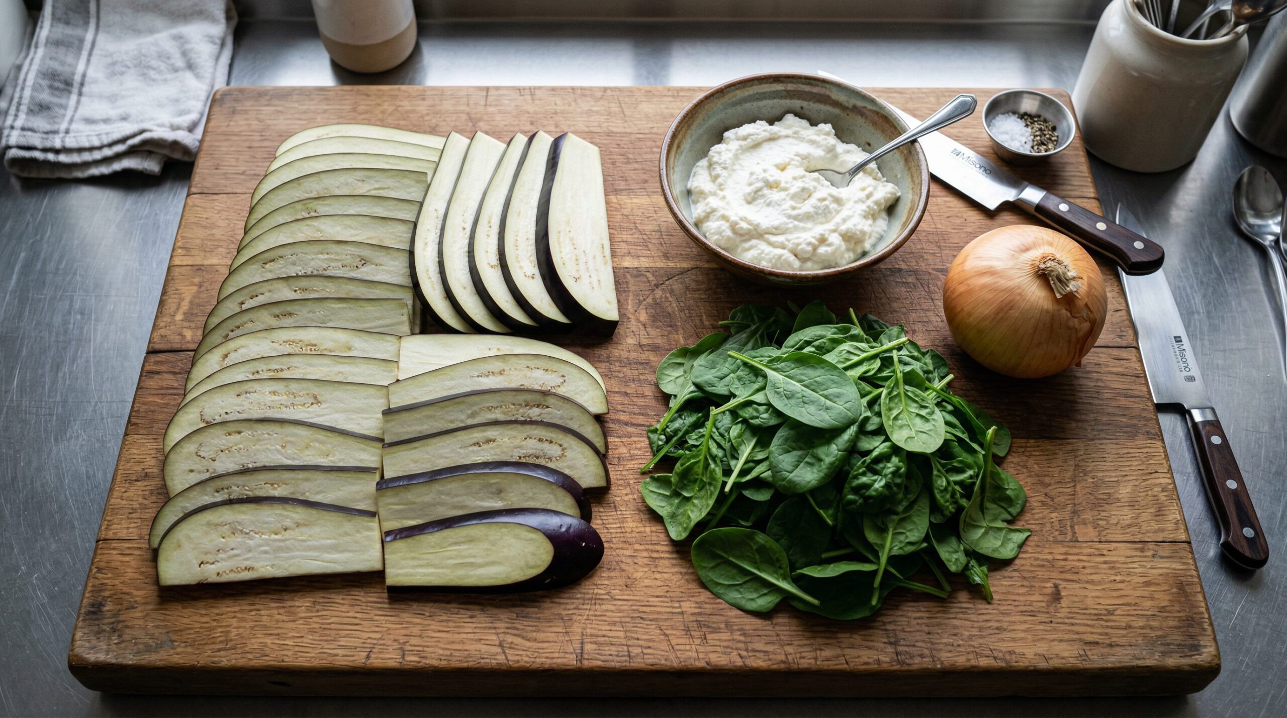 Roasted eggplant slices, spinach, ricotta, and Parmesan arranged to make rollatini